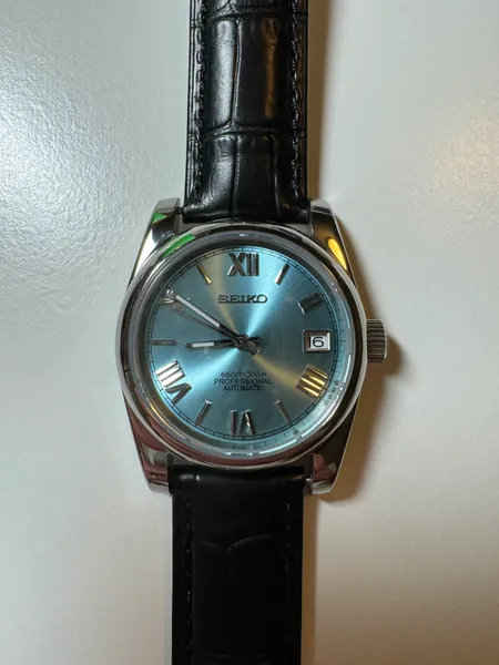 Blue-dial watch on a black leather strap