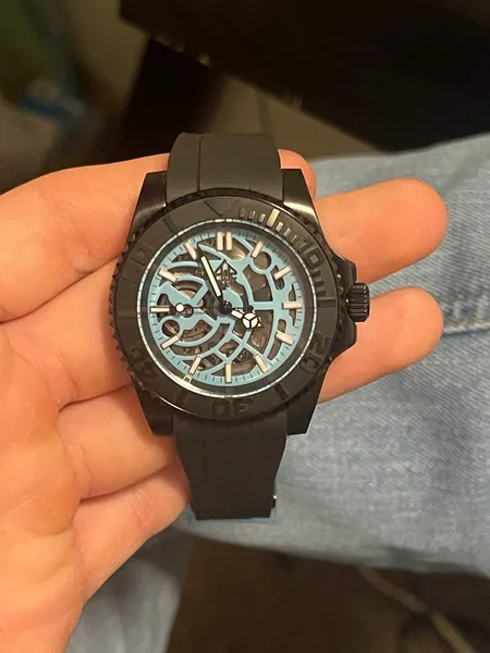 Black skeleton-dial watch with a rubber strap